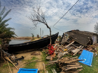 A woman in front of her destroyed house caused by the cyclone. She lost every necessary material after Cyclone YAAS from regular tides while...