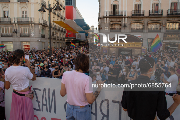 Young people holding a poster in front of hundreds of people in Madrid, Spain, on July 5, 2021 during a protest following the murder of Samu...