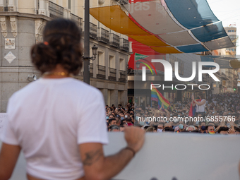 A young person holding a poster in front of hundreds of people in Madrid, Spain, on July 5, 2021 during a protest following the murder of Sa...
