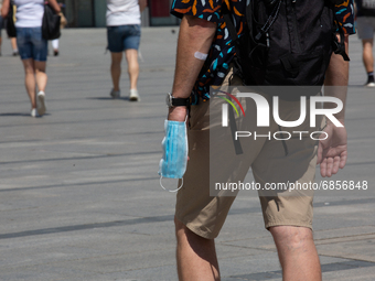 People in their summer outfit walk in the old town of Krakow as another heat wave approaches Poland and central Europe on  July 6, 2021. Kra...