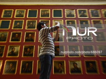 man is taking a picture in one of the halls of the Hermitage, Saint Petersburg, Russa on July 12, 2015 (