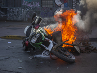 A police motorcycle burns in the middle of the funeral of Luisa Toledo Sepulveda, mother of brothers Rafael(18) and Eduardo Vergara Toledo(1...