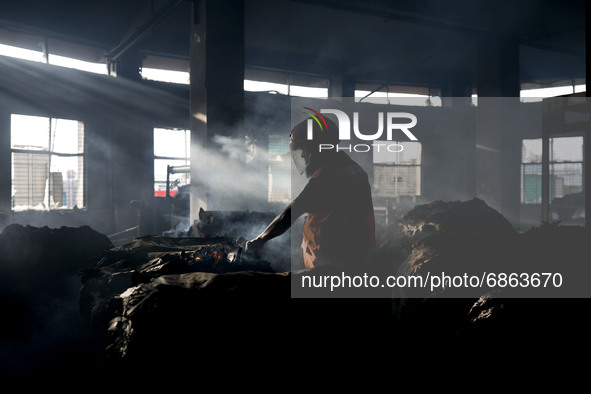 A firefighter inspects the inside of a Hashem Foods Ltd factory where a fire broke out, in Rupganj, Narayanganj district, on the outskirts o...