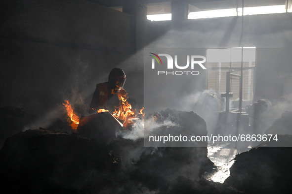 A firefighter inspects the inside of a Hashem Foods Ltd factory where a fire broke out, in Rupganj, Narayanganj district, on the outskirts o...