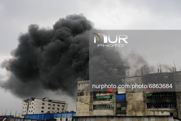 Firefighters work at the scene of a fire that broke out at a factory named Hashem Foods Ltd. in Rupganj of Narayanganj district, outskirts o...