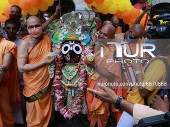 Temple priests and Hindu devotees carry an idol of Lord Jagannath as a symbolic gesture after the Rath Yatra procession was cancelled amid c...