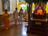 Devotees stands beside an idol of Swami Prabhupada , on of the pioneers of Kolkata Isckon , during Rathyatra festival in Kolkata, India, on...
