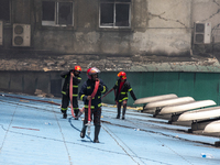Firefighter's and rescue workers try to extinguish a massive fire that broke out at the Hashem Foods Ltd at Rupganj, on the outskirts of Dha...