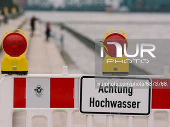 Warns sign against flood is seen along rhine promenade in Cologne, Germany on July 13, 2021 as heavy rainfall has caused flooding (