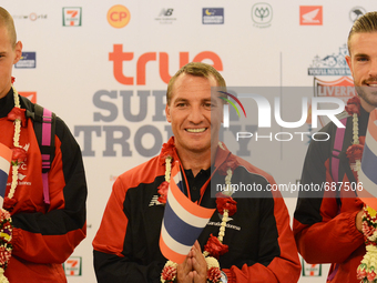 (L-R) Martin Skrtel, Brendan Rodgers and Jordan Henderson of Liverpool pose with Thailand flag as they arrive at Suvarnabhumi airport in Sam...