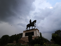 Dark clouds hover over Maharaja Sawai Man Singh II statue (who ruled  as a King of Jaipur 1922-1948) during the Mansoon season , in Jaipur ,...