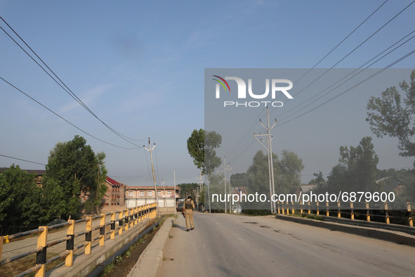 Indian police forces stand on a deserted road during a military operation in Srinagar, Indian Administered Kashmir on 16 July 2021. Two mili...