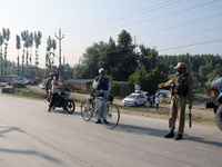 Indian policeman stop civilians during a military operation in Srinagar, Indian Administered Kashmir on 16 July 2021. Two militants were kil...