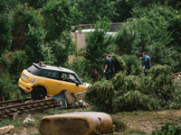a car is seen stucked on the railway track in Iversheim, Germany on July 17, 2021 as heavy rainfalls causes serious damages in several parts...