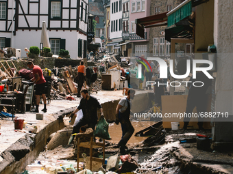 people clean up the debris in the city center of Bad Muenstereifel, Germany on July 17, 2021 as heavy rainfalls causes serious damages in se...
