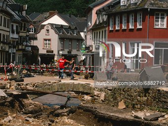 people look at the debris in the city center of Bad Muenstereifel, Germany on July 17, 2021 as heavy rainfalls causes serious damages in sev...