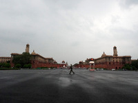 A security personnel walks past Rajpath after a light spell of rain at the Raisina hills, in New Delhi, India on July 18, 2021. (
