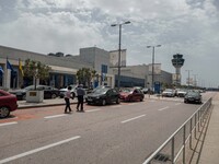 Exterior of the departure area and the control tower of Athens Airport. Passengers with face masks as seen at Athens International Airport A...