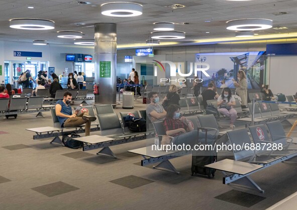 People in the waiting area in front of the gates in Athens Airport. Passengers with face masks as seen at Athens International Airport ATH L...