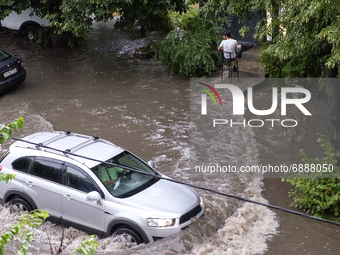 The car driving on a flooded street during a heavy downpour in Kyiv, Ukraine. July 19, 2021  (