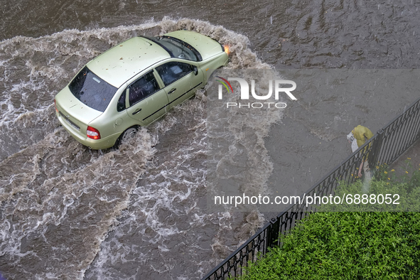 The car driving on a flooded street during a heavy downpour in Kyiv, Ukraine. July 19, 2021  
