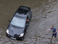 The car driving on a flooded street during a heavy downpour in Kyiv, Ukraine. July 19, 2021  (
