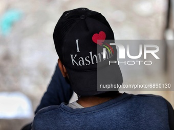 I Love Kashmir is written on the cap of a boy as he sits on the stairs of a Commercial complex in Sopore District Baramulla Jammu and Kashmi...