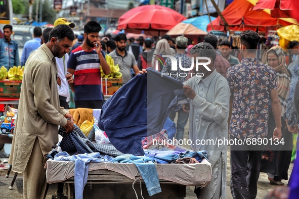 People purchase goods ahead of Muslim festival Eid-Ul-Adha in Sopore town of District Baramulla Jammu and Kashmir India on 20 July 2021. 