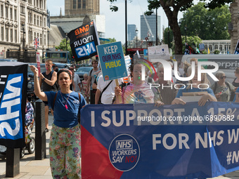 LONDON, UNITED KINGDOM - JULY 20, 2021: NHS staff, members of the trade unions and health campaigners takes part in a protest march through...