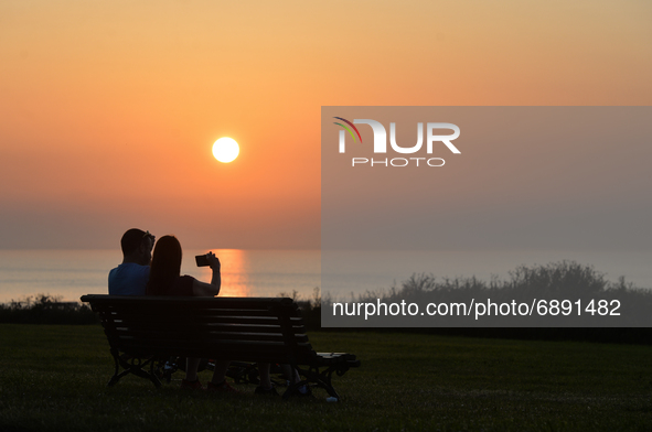 Couple watching the sunset near Arromanches.
On Wednesday, July 20, 2021, in Arromanches, Calvados, Normandy, France. 