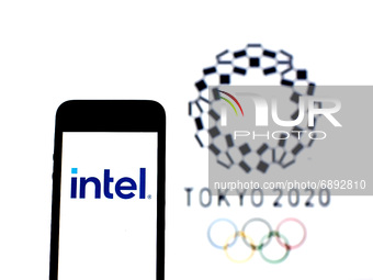 In this photo illustration a Intel Corporation logo seen displayed on a smartphone with a Tokyo 2020 Olympic Games logo in the background. (