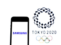 In this photo illustration a Samsung Electronics Co., Ltd. logo seen displayed on a smartphone with a Tokyo 2020 Olympic Games logo in the b...