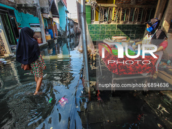 Residents' activities amid tidal flooding in a fishing village in Tambaklorok, Semarang, Central Java Province, Indonesia on July 21, 2021....