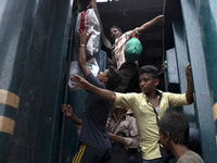 People travel on a train leaving for their hometowns for the upcoming festival Eid-ul-Fitre at the Airport Railway Stationin Dhaka on 14th J...
