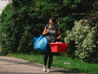a woman carries some items leaving the area in Erftstadt, Germany on July 22, 2021 as a majoy flooding in Germany (