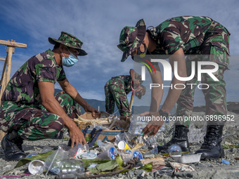 Indonesian Army soldiers collect plastic waste scattered in the Talise Beach area, Palu, Central Sulawesi Province, Indonesia on July 23, 20...
