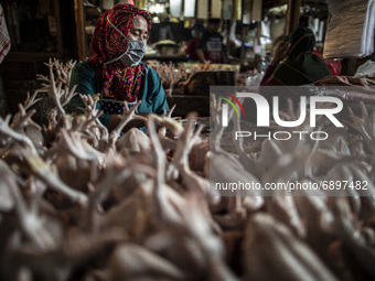 Gloomy faces of sellers and buyers at a traditional market in Pamulang area, South Tangerang, Banten, Indonesia on July 23, 2021. For almost...