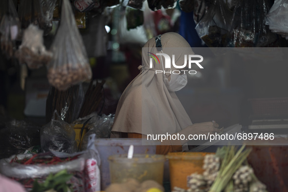 Gloomy faces of sellers and buyers at a traditional market in Pamulang area, South Tangerang, Banten, Indonesia on July 23, 2021. For almost...