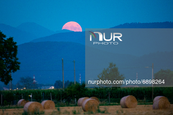 The almost full Moon, is 95% rises over the skies of Rieti, Italy on July 23, 2021. he month of July will be the only one in 2021 to host 5...