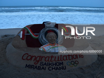 A congratulation sand art is seen at the Bay of Bengal Sea's Puri beach, 65 km away from the eastern Indian state Odisha's capital city Bhub...