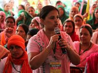 A woman farmer addresses the crowd during a mock parliament as the farmers' protest against three farm laws completes eight months, in New D...