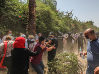 Supporters of the Islamist party Ennahdha clash with riot police during a sit-in protest led by the Tunisian Parliament Speaker Rached Ghann...