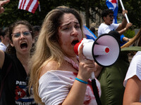 Demonstrators yell at bystanders during a march from the White House to the Cuban Embassy in Washington, D.C. on July 26, 2021 (