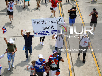 Demonstrators march under an overpass during a demonstration for Cuban rights in Washington, D.C. on July 26, 2021 (