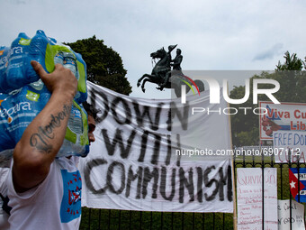 A man carries water for demonstrators during a Cuban freedom rally at the White House on July 26, 2021 (