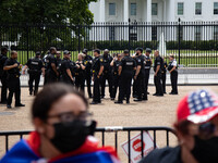 Thousands of demonstrators rally at the White House as Secret Service officers stand on patrol in Washington, D.C. on July 26, 2021 (