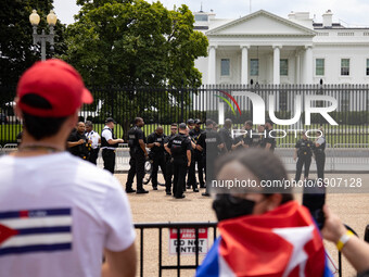 Thousands of demonstrators rally at the White House as Secret Service officers stand on patrol in Washington, D.C. on July 26, 2021 (