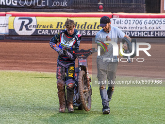 Vinnie Foord   and his mechanic carry the damaged bike back to the pits after his heat 9 fall during the National Development League match b...