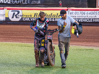 Vinnie Foord   and his mechanic carry the damaged bike back to the pits after his heat 9 fall during the National Development League match b...