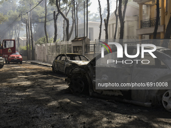 Burnt cars following a forest fire at Dionysos northern suburb of Athens, on Tuesday, July 27, 2021.  (
